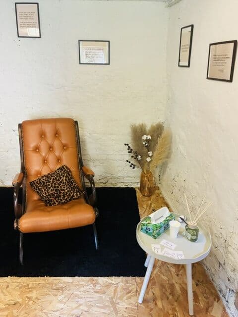 Le fauteuil en cuir du cabinet, avec son coussin et une table basse